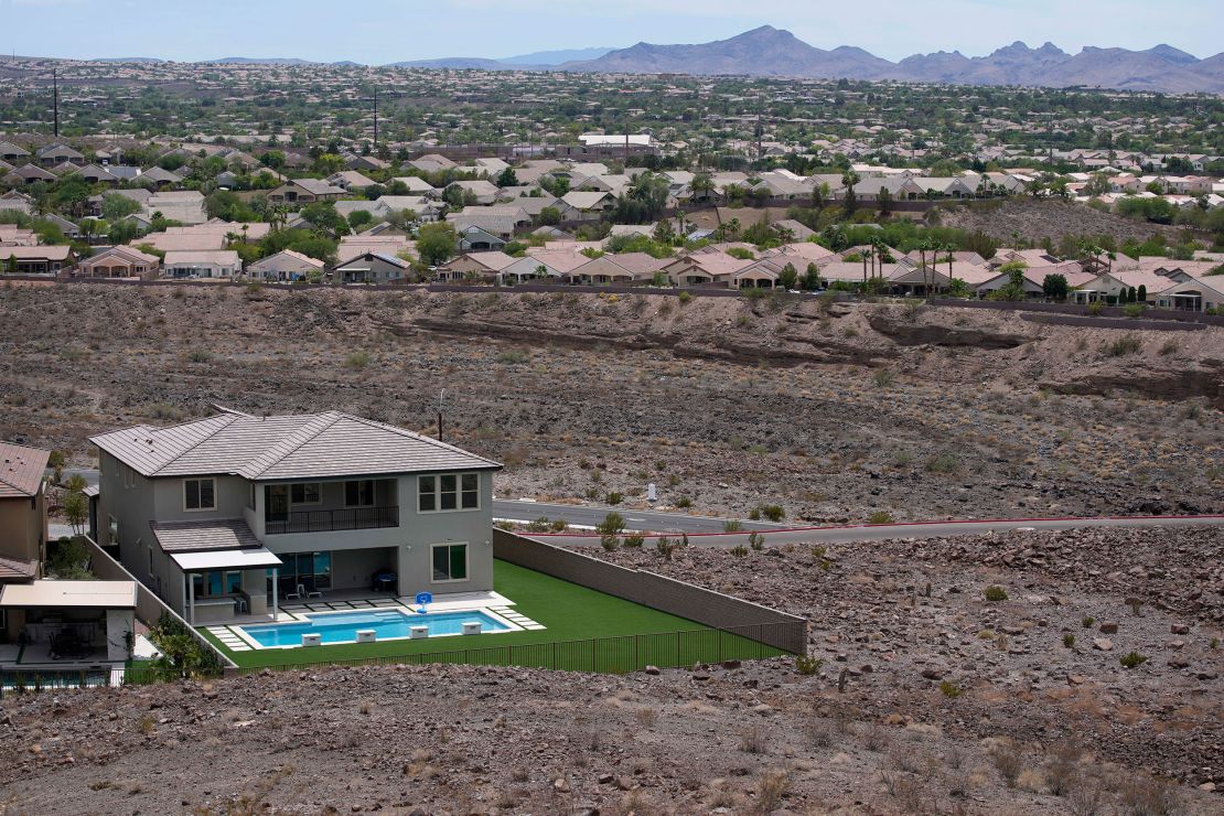 A home with a swimming pool abuts the desert on the edge of the Las Vegas valley in Henderson, Nevada. Officials are considering capping the size of new swimming pools because of the drought.
