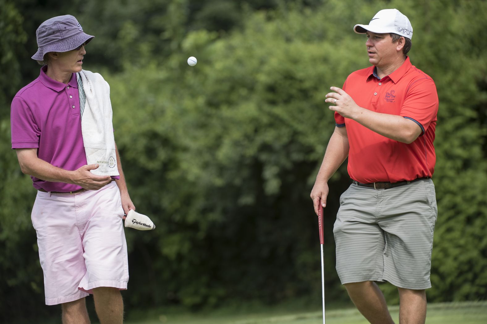 US Rep. Trey Gowdy, left, tosses a golf ball to DeSantis during the First Tee Congressional Challenge golf tournament in July 2015.