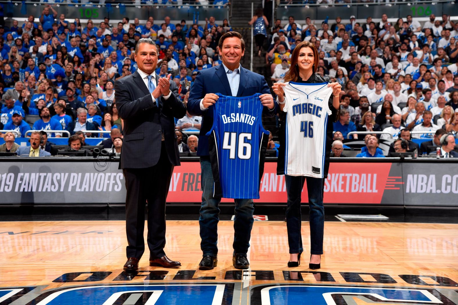 DeSantis and his wife hold up Orlando Magic jerseys before an NBA playoff game in April 2019.