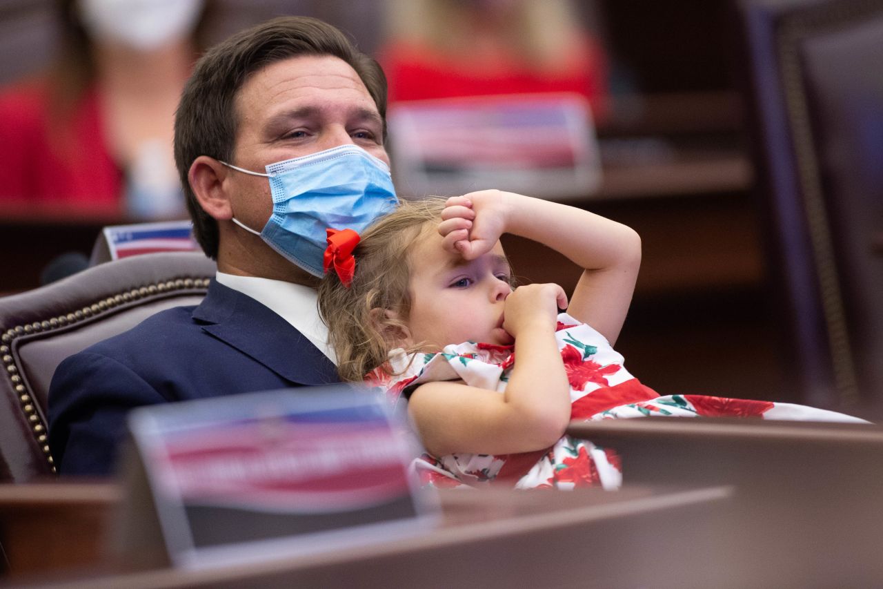 DeSantis and his daughter Madison lean back in a chair during a meeting of the Florida presidential electors in Tallahassee, Florida, in 2020.
