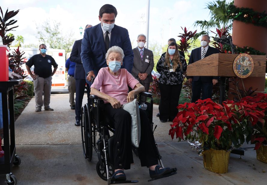 DeSantis pushes Vera Leip, 88, in her wheelchair after she received a Covid-19 vaccine in Pompano Beach, Florida, in December 2020. Leip's retirement community was one of the first in the country to receive vaccinations.