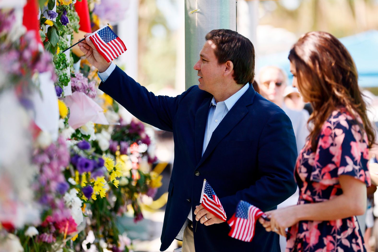 The DeSantises visit a memorial for those missing after the partial collapse of a residential building in Surfside, Florida, in July 2021.