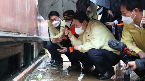 South Korean President Yoon Suk Yeol visits the flooded semi-basement in Seoul's Gwanak, where a family has died in flooding, on Aug. 10.