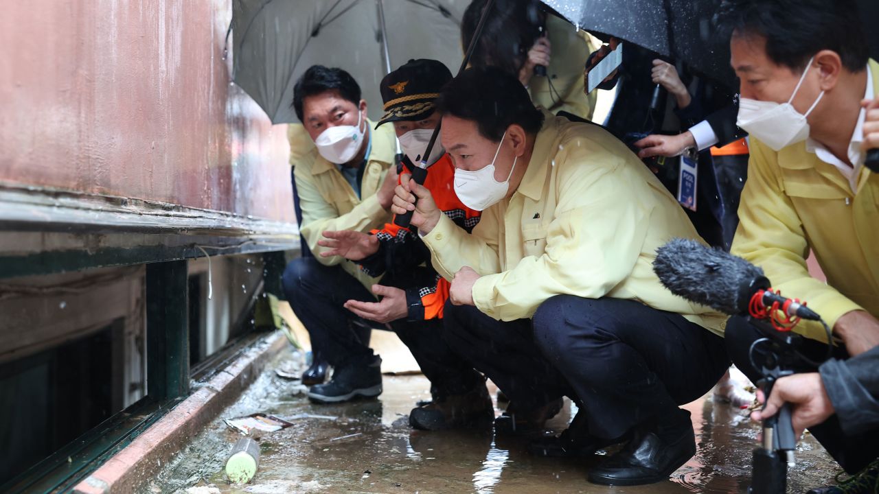 South Korean President Yoon Suk Yeol visits the flooded semi-basement in Gwanak of Seoul, where a family died from flooding, on August 10.