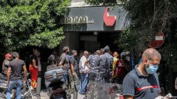 Security forces gather outside a "Federal Bank" branch in Lebanon's capital Beirut on August 11, 2022. - A customer armed with a rifle and threatening to set himself ablaze held bank workers hostage on August 11 in Lebanon's capital demanding to withdraw his savings of over $200,000, security sources said. The incident is the latest between local banks and angry depositors unable to access their savings after Lebanon's economic collapse, because of informal capital controls. An AFP correspondent saw security forces surrounding a branch near the busy Hamra commercial street in west Beirut. (Photo by anwar amro / AFP) (Photo by ANWAR AMRO/AFP via Getty Images)