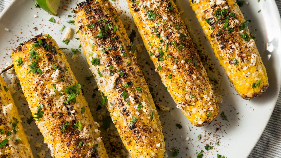 The Mexican corn dish elote features corn on the cob with mayonnaise, lime juice and cheese.