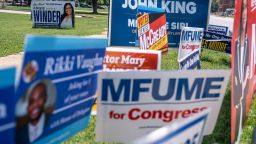 Campaign signs line the road near a polling place at The League for People with Disabilities  during the midterm primary election on July 19, 2022 in Baltimore, Maryland.