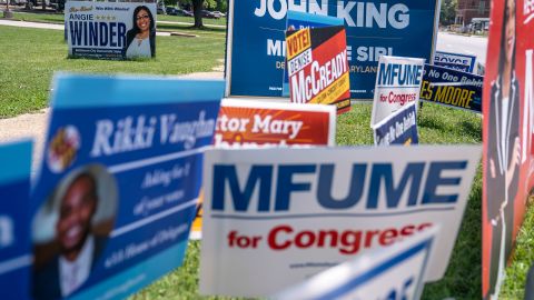 Campaign signs line the road near a polling place at The League for People with Disabilities  during the midterm primary election on July 19, 2022 in Baltimore, Maryland.