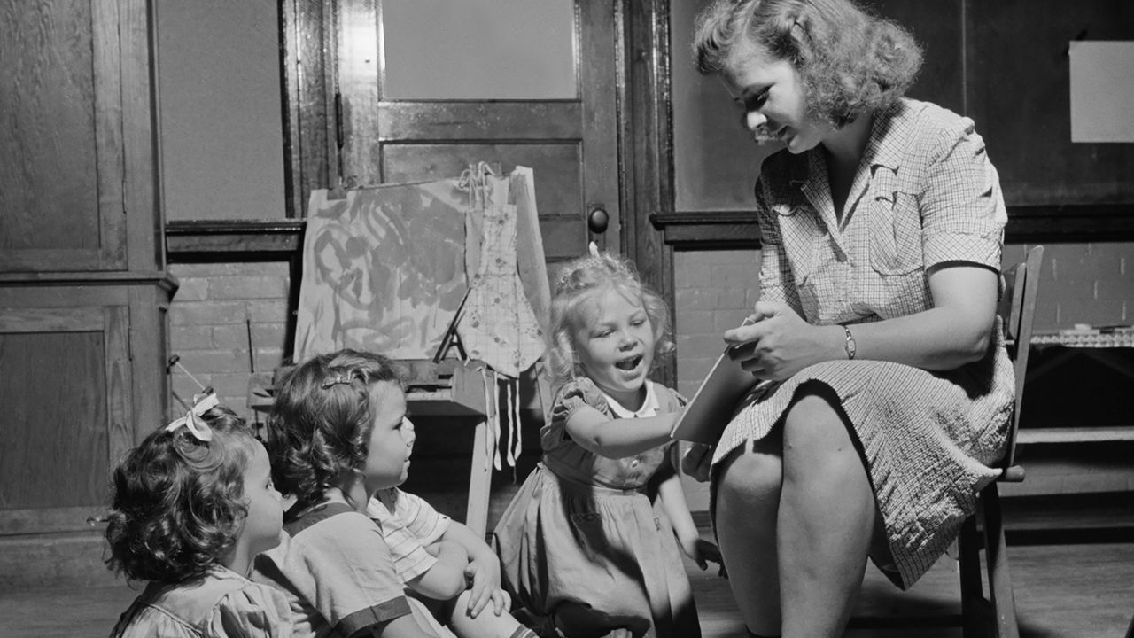 A woman reads to children at a childcare center in New Britain, Connecticut, in 1943.