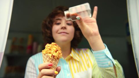 Someone eats ice cream from an ice cream cone in the La Dolce Velveeta commercial.