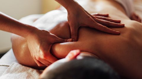 Getting a massage is one option to help speed up recovery when you have muscle knots.