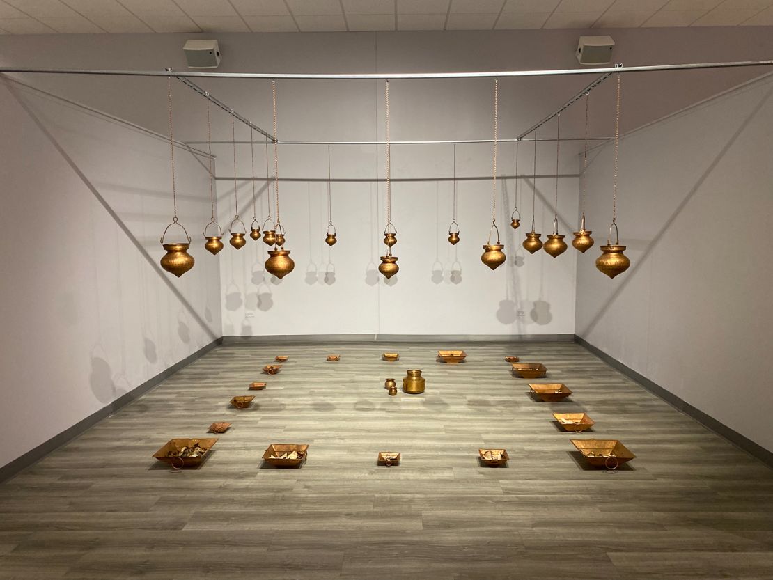The installation "Memory Leaks" is composed of 17 copper vessels called "dharapatras."