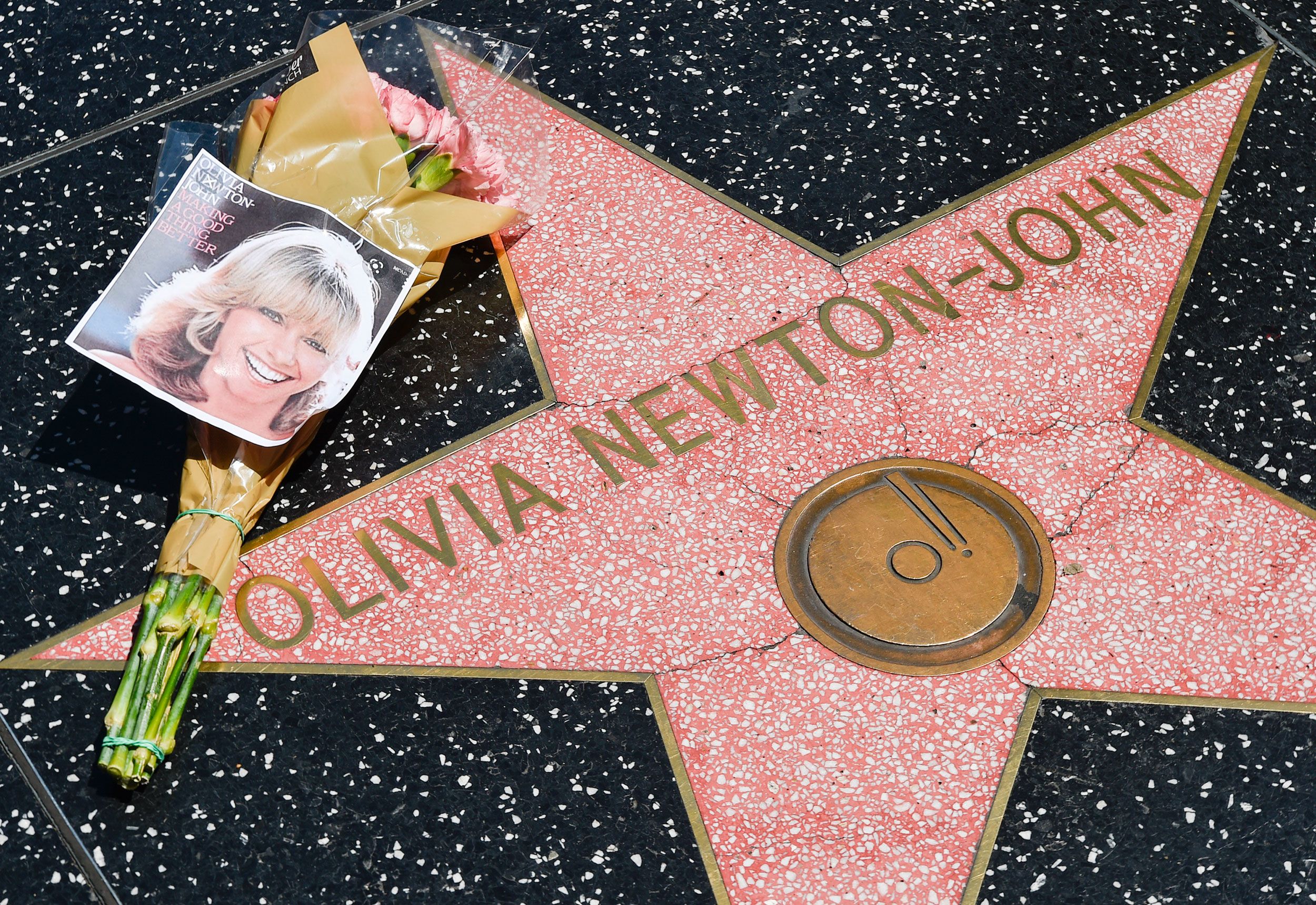 Flowers seen on Olivia Newton-John's star on the Hollywood Walk of Fame on Monday, August 8.