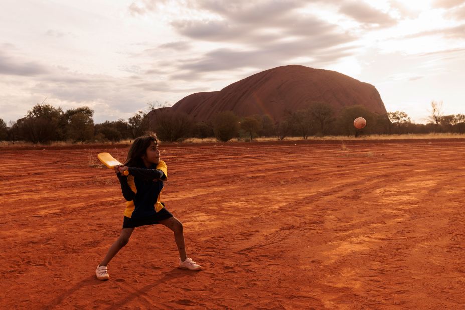 A child plays cricket in Mutitjulu, an Aboriginal community in Uluru, Australia, on Tuesday, August 9. The community was one of the stops on the ICC Men's T20 World Cup Trophy Tour.