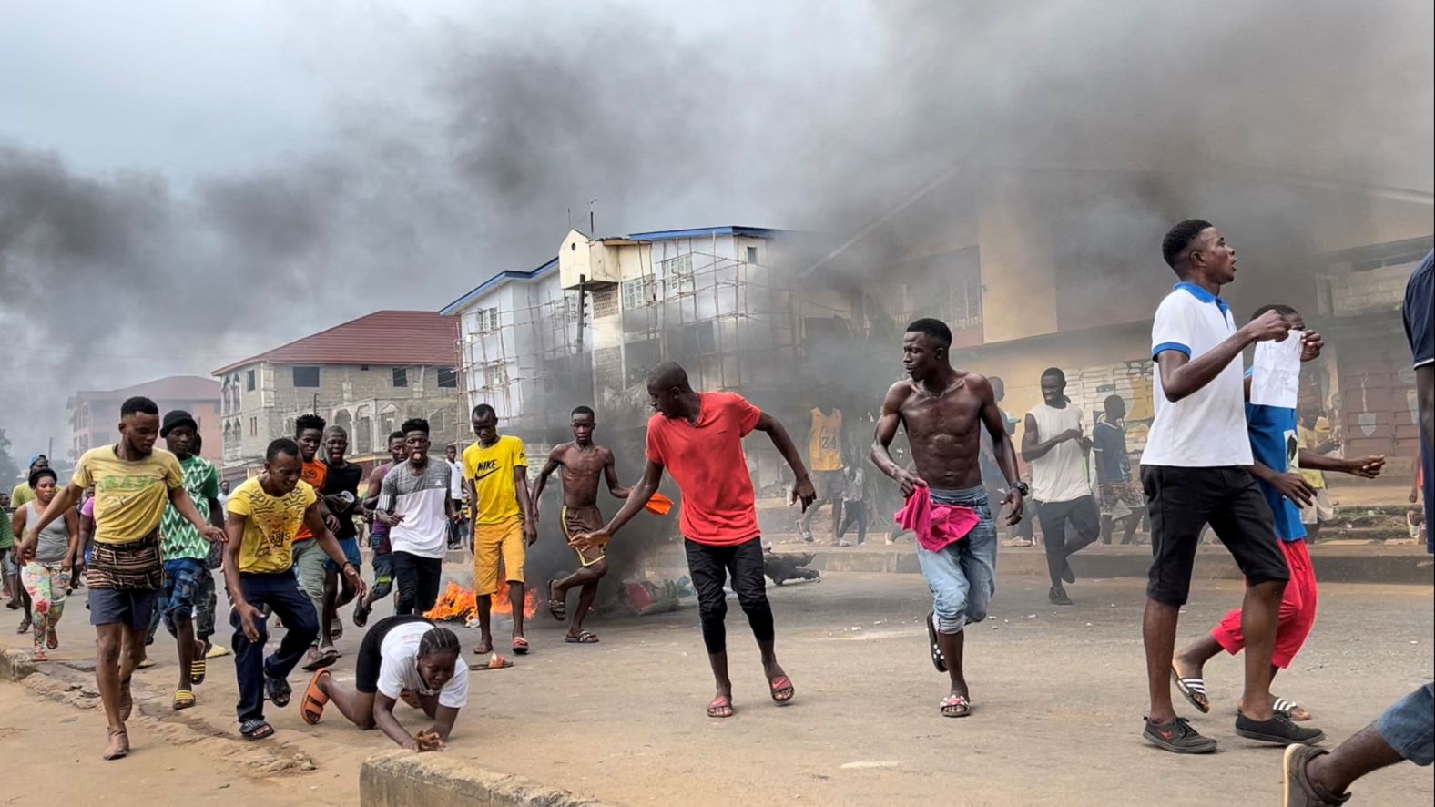 People run away during an anti-government protest in Freetown, Sierra Leone, on Wednesday, August 10. Hundreds of protesters took to the streets of the capital, protesting inflation and the rising cost of living in the West African country. <a href="https://www.cnn.com/2022/08/11/africa/eight-killed-sierra-leone-protest-intl/index.html" target="_blank">The protests grew violent at times, and there were casualties.</a> Eight police officers were killed, the country's youth minister told CNN on Thursday, while hospital sources told Reuters that at least 21 civilians were killed in different locations in the country.