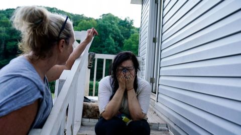 Kirsten Gomez, right, cries to her family member Kathy Hall, after what she calls a quiet moment to reflect on what her family has gone through in the aftermath of massive flooding, Tuesday, August 2, 2022, in Hindman, Kentucky.