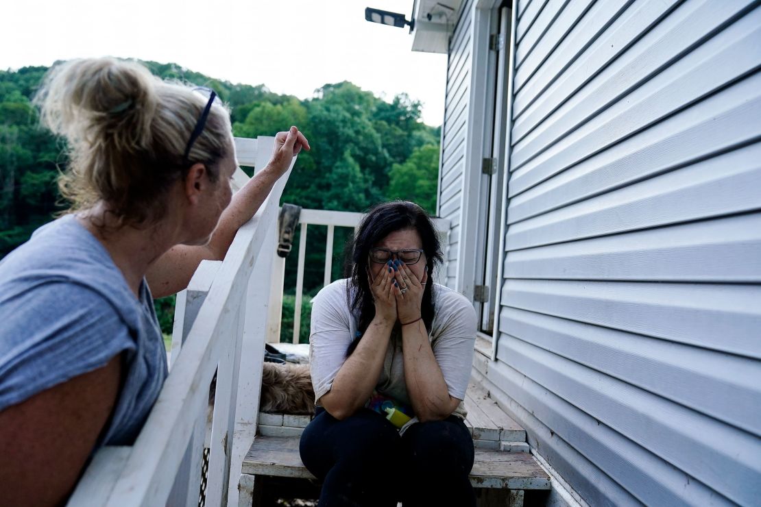 Kirsten Gomez, right, cries to her family member Kathy Hall, after what she calls a quiet moment to reflect on what her family has gone through in the aftermath of massive flooding, Tuesday, August 2, 2022, in Hindman, Kentucky. 