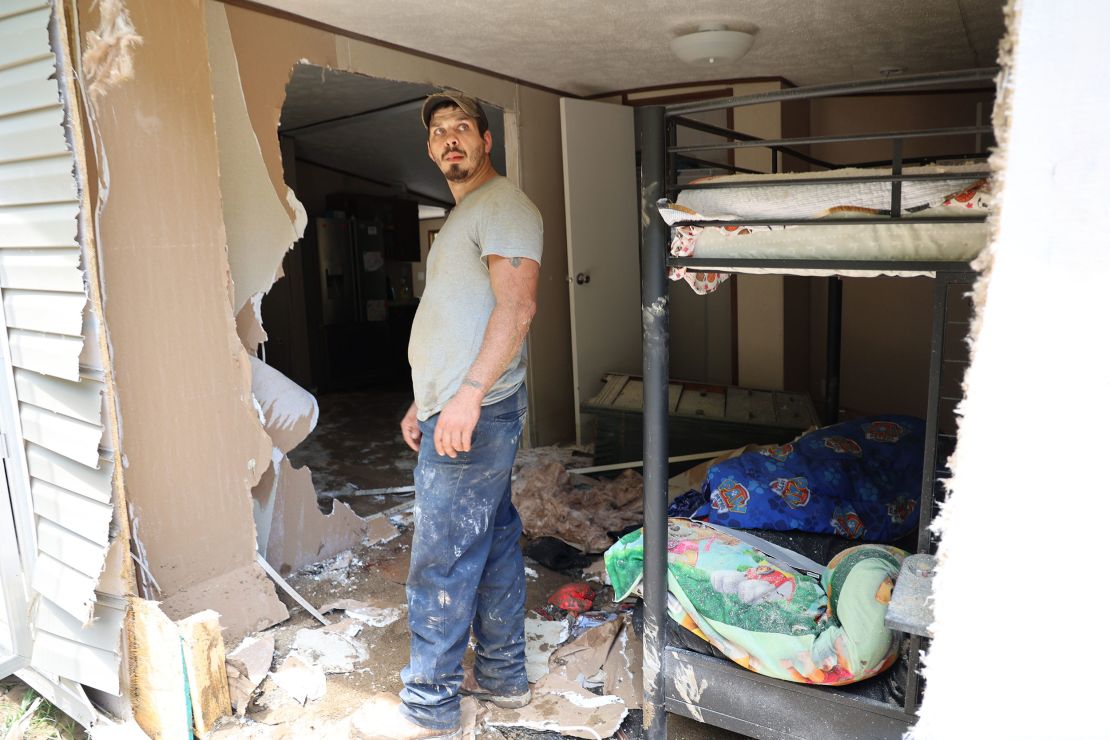 Dustin Elam, 31, stands in his children's former bedroom after his home was destroyed by flooding in Breathitt County, Kentucky.