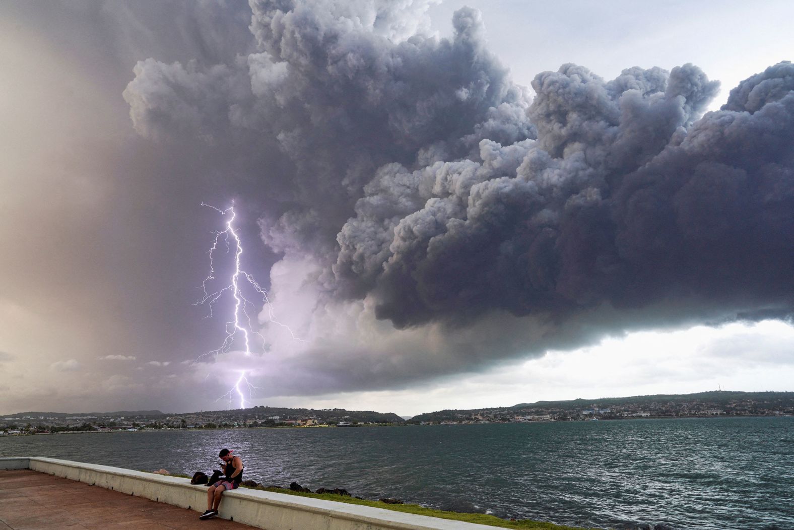 Lightning strikes through smoke near a fuel depot in Matanzas, Cuba, on Monday, August 8. <a href="https://www.cnn.com/2022/08/06/americas/cuba-lightning-strike-oil-storage-fire-intl-hnk/index.html" target="_blank">A massive fire at the fuel depot</a> was caused by a lightning strike.