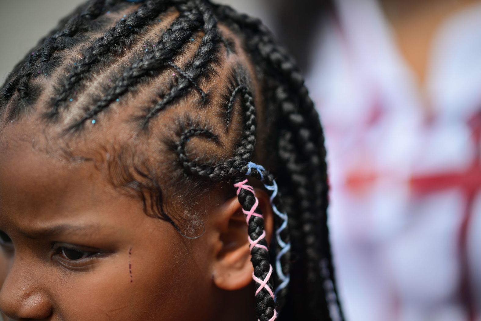 A girl has a heart braided into her hair during a back-to-school drive in Atlanta on Sunday, August 7. The annual event, hosted by rapper 21 Savage, provided school supplies, uniforms and shoes for the children in attendance.