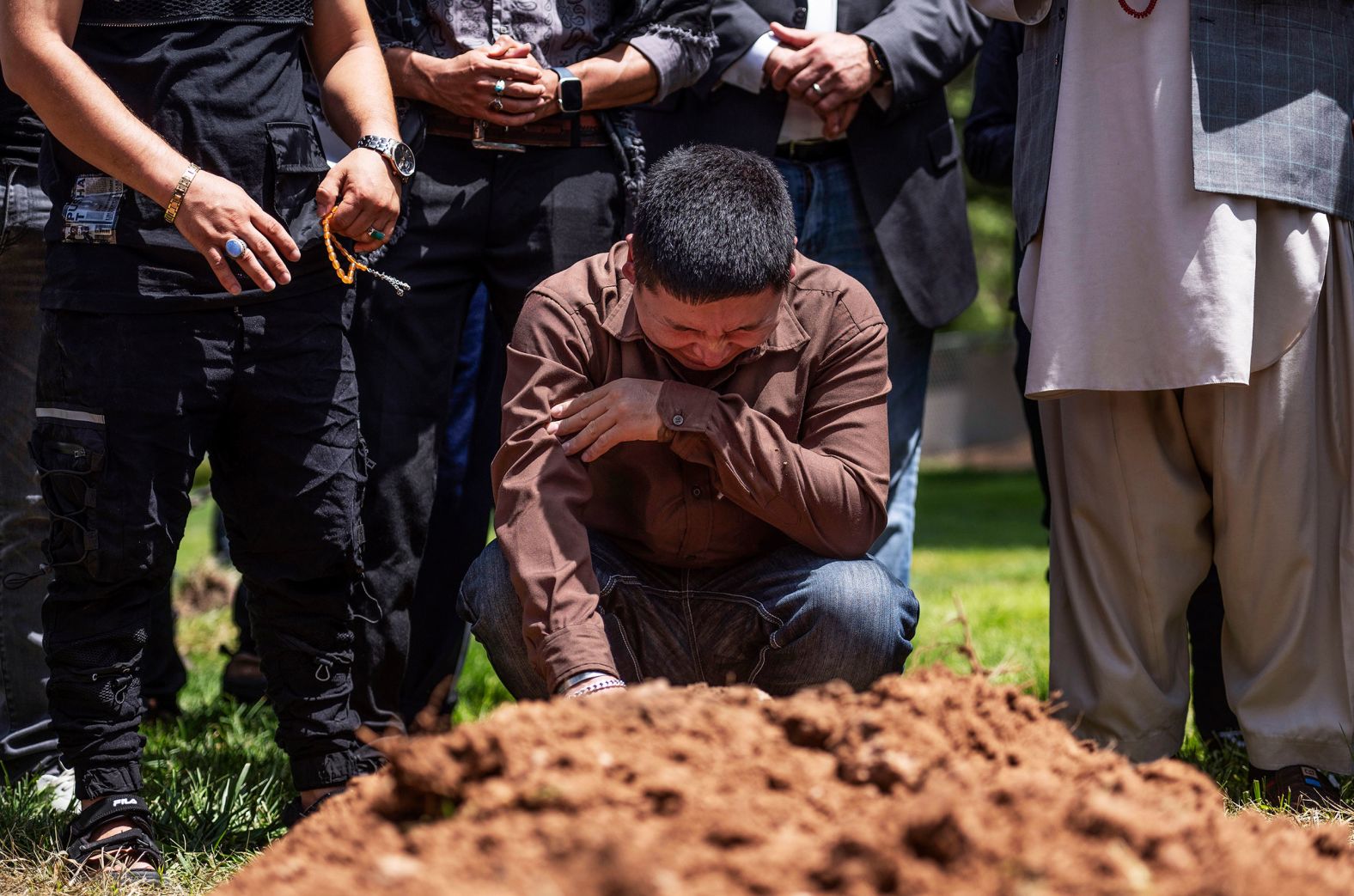 Altaf Hussain cries over the grave of his brother Aftab during a funeral in Albuquerque, New Mexico, on Friday, August 5. The potentially linked ambush-style shootings of three Muslim men and the recent killing of a fourth in Albuquerque <a href="https://www.cnn.com/2022/08/08/us/albuquerque-muslim-men-killings-monday/index.html" target="_blank">have alarmed the city's Muslim community,</a> leaving it grappling with fear as police announced they have detained a suspect.