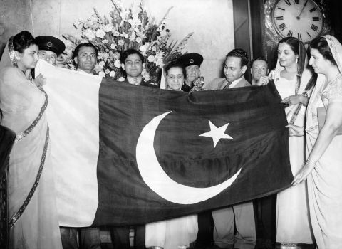 A civil commission of Pakistanis presents the flag of the nation during a ceremony at Lancaster House in London, on August 15, 1947. 