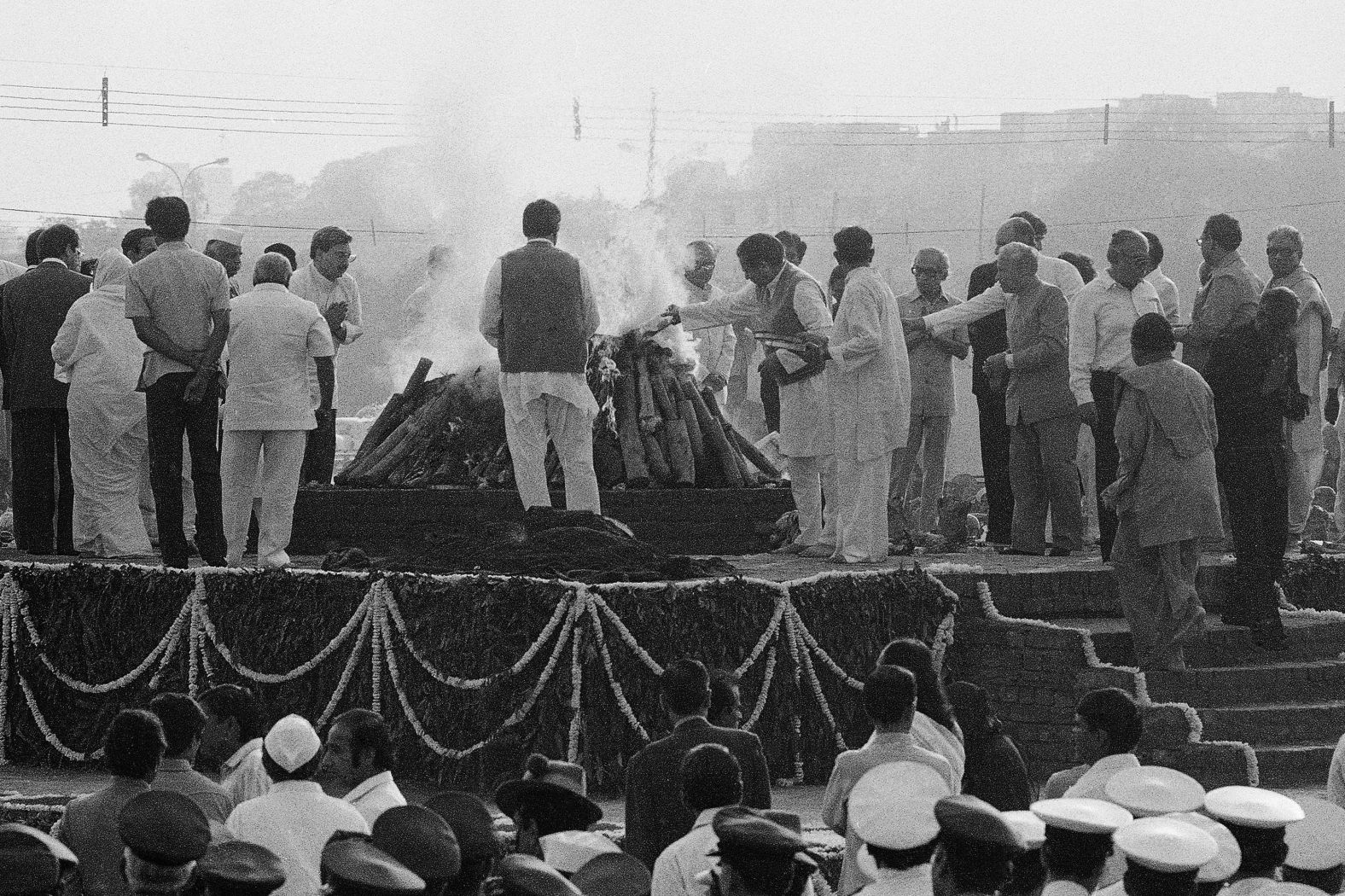 The body of assassinated Indian Prime Minister Indira Gandhi is covered with flowers on a pyre as it is set afire on November 3, 1984, after she was shot by her own security guards.