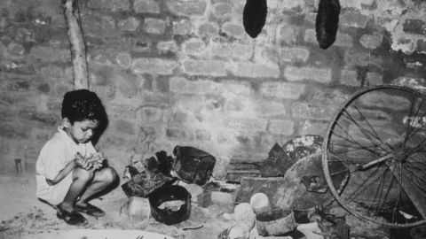 A young child in an abandoned ammunition dump in Delhi, after communal riots between Hindus and Muslims in 1947.  