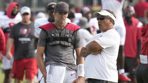 Brady talks with coach Clyde Christensen.