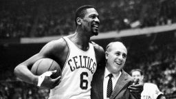 In this Dec. 12, 1964, file photo, Boston Celtics' Bill Russell, left, is congratulated by coach Arnold "Red" Auerbach after scoring his 10,000th career point during an NBA basketball game against the Baltimore Bullets at the Boston Garden in Boston. 