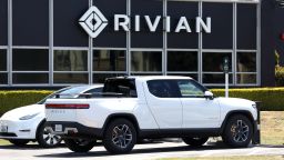 A Rivian electric pickup truck sits in a parking lot at a Rivian service center on May 09, 2022 in South San Francisco, California. Shares of Rivian stock fell 13 percent after Ford, which currently owns as 11.4 percent stake in the electric car maker, is planning to sell 8 million of its 102 million shares.