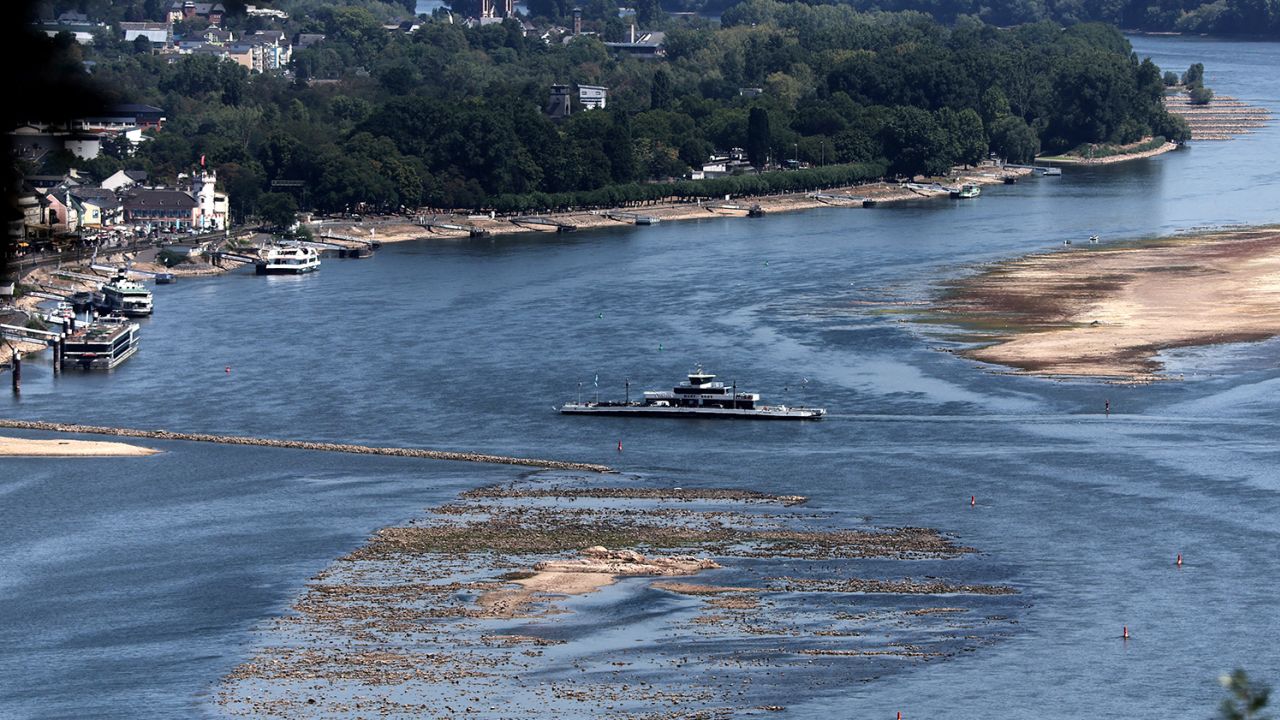 A ferry cruises past the partially dried riverbed of the Rhine river in Bingen, Germany on Aug. 9.