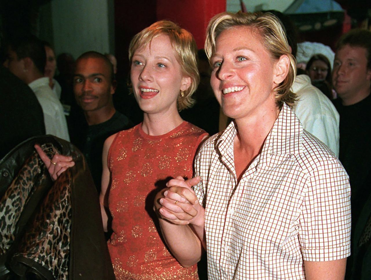 Heche, left, holds hands with comedian Ellen DeGeneres at the world premiere of the movie "Face/Off" in 1997. The two dated for several years.