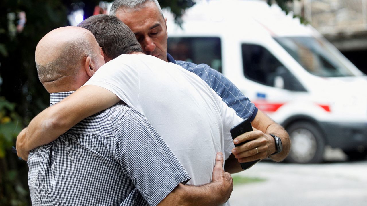 Relatives of victims comfort each other at a crime scene after a mass shooting in Cetinje, Montenegro August 12, 2022.
