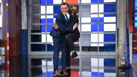 Stephen Colbert hugs his newly named bandleader Louis Cato.