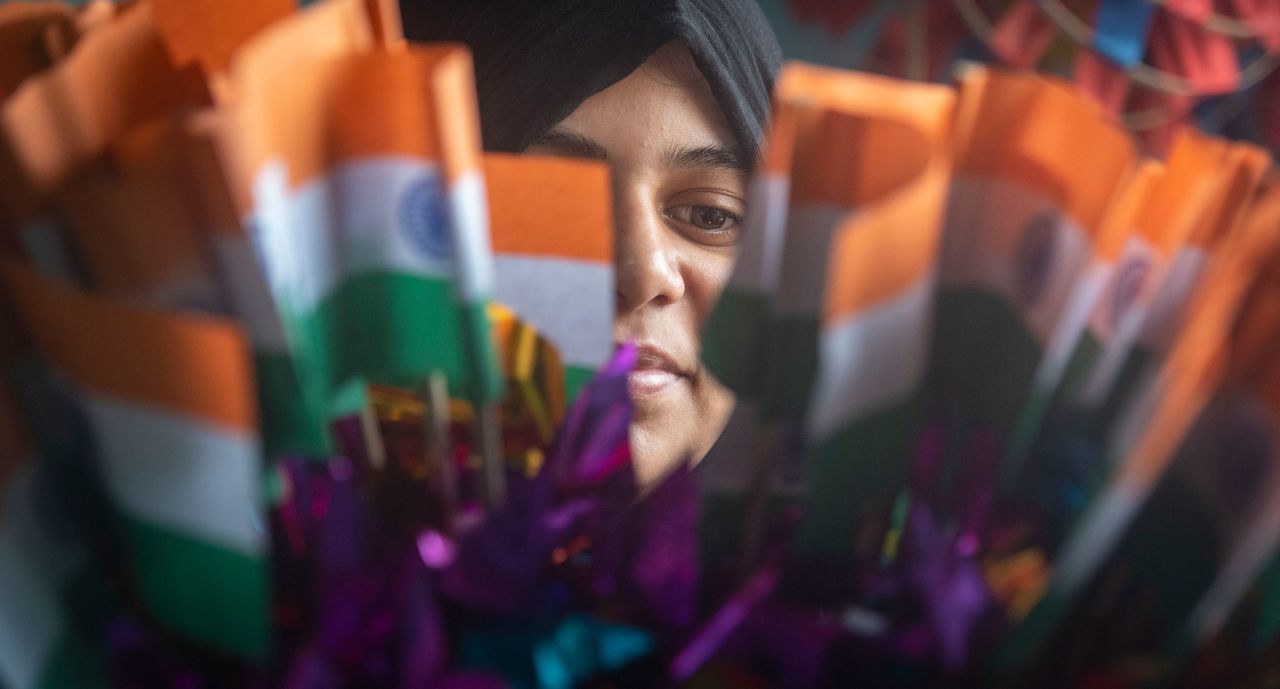 A woman looks at Indian national flags ahead of the 75th Independence day on August 4, 2022 in Pune, India.