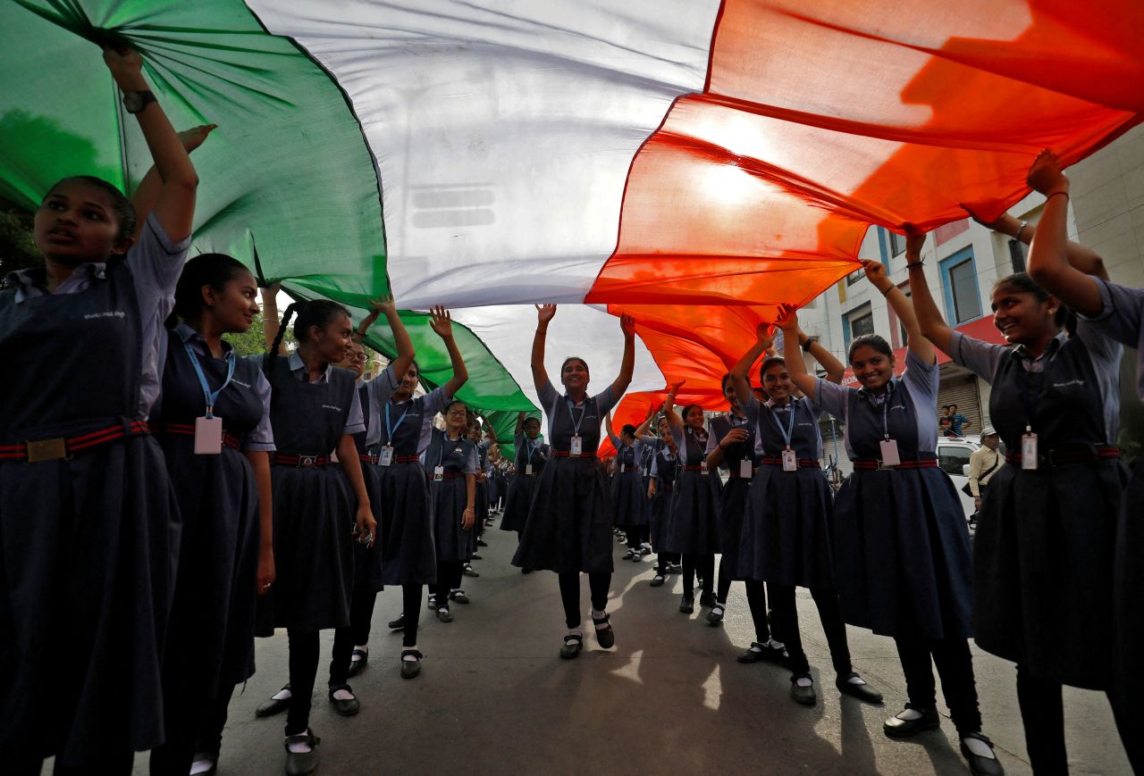 Students carry an Indian national flag ahead of the country's 75th independence day celebrations in Ahmedabad, India, August 8, 2022.