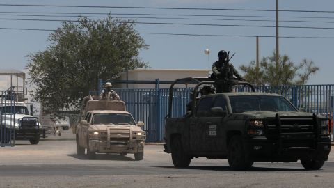 Members of the National Guard and the Mexican Army leave the airport Friday after landing in the Mexican border city of Juarez following a spate of violence.
