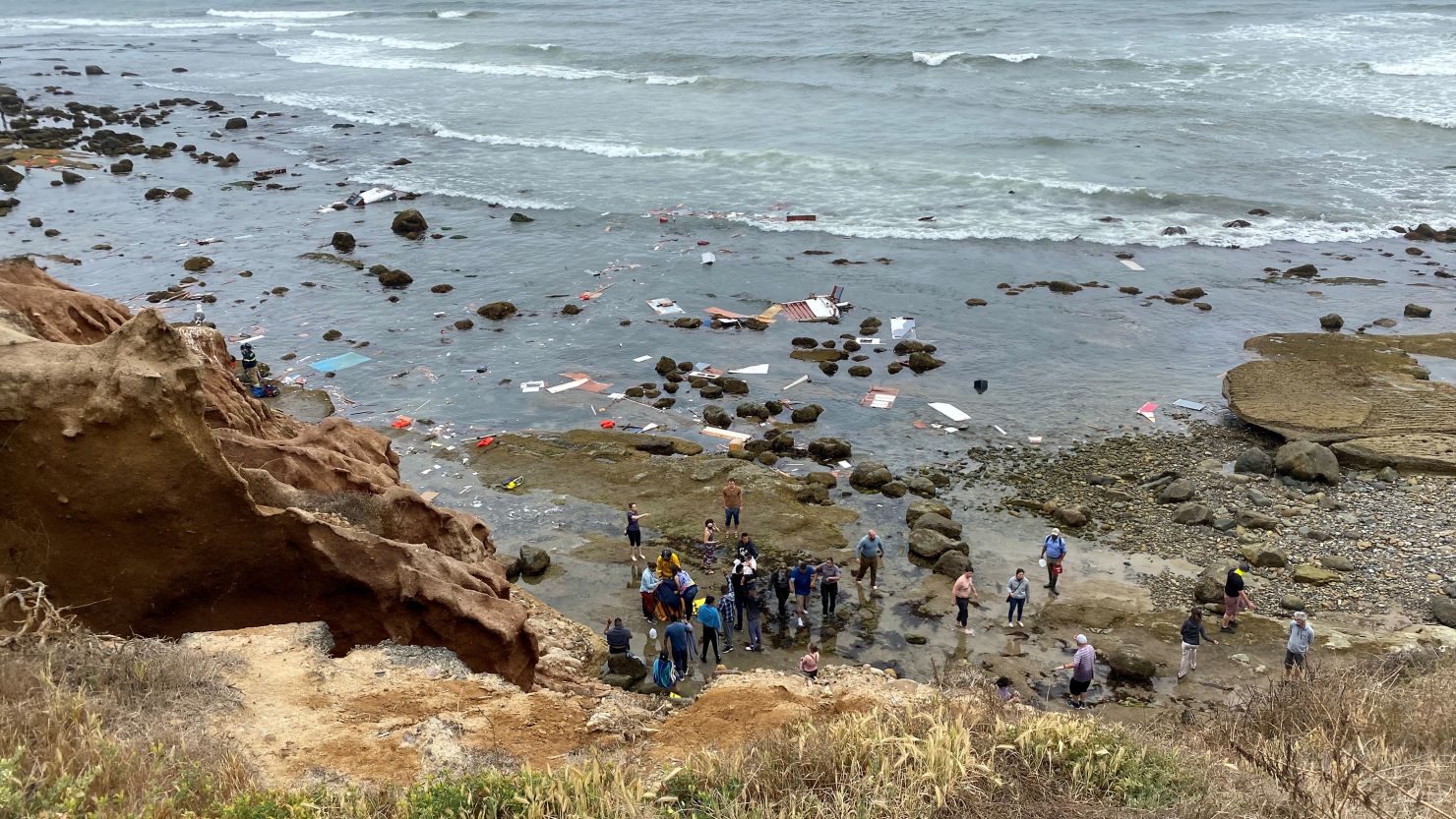 People gather after a boat carrying migrants from Mexico shipwrecked off San Diego in May 2021.