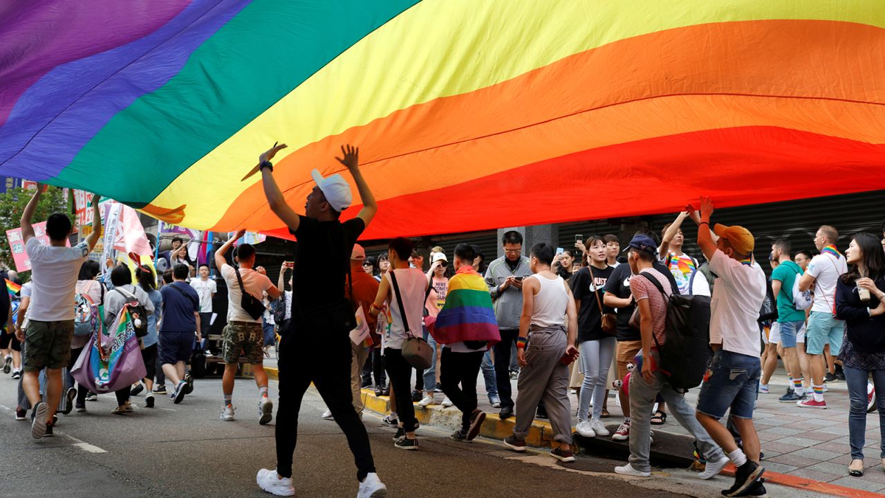 Participants march under a rainbow flag during the LGBT Pride parade in Taipei, Taiwan, on October 26, 2019.
