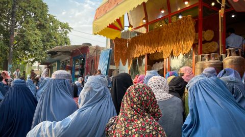 Women gather outside a bakery in Kabul, hoping for a handout from customers. 