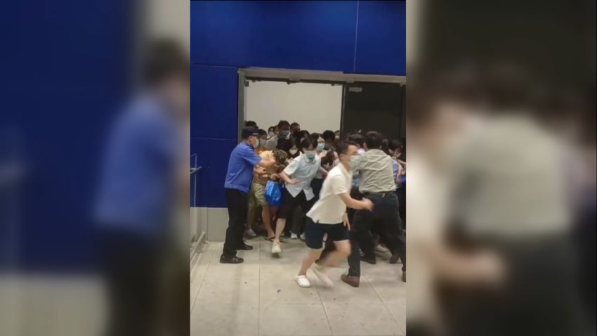 Shanghai shoppers attempt to get out of an Ikea store to escape Covid-19 controls.