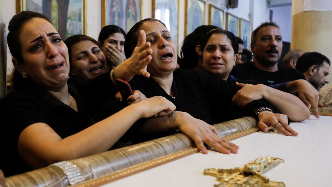 Mothers of three children who died during the fire attend a funeral for them and other victims on Sunday.