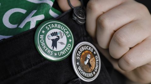 An employee in Jacksonville, Florida shows off buttons in support of unionizing Starbucks.