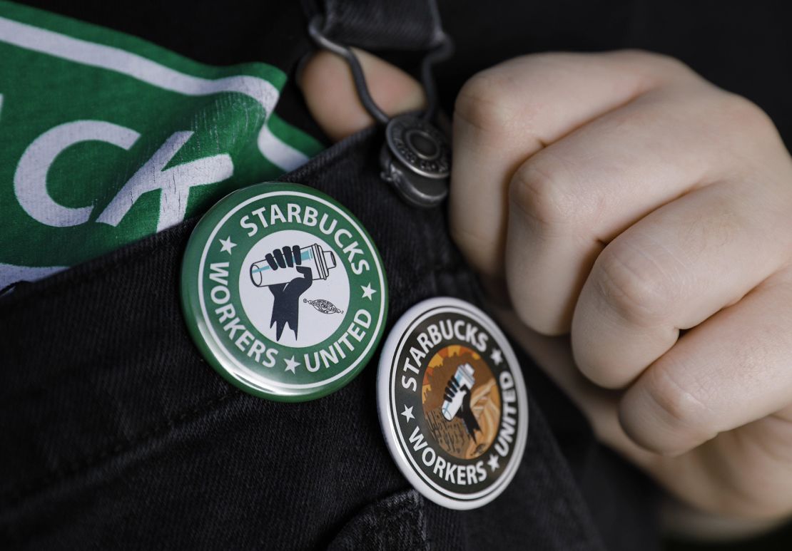 An employee in Jacksonville, Florida shows off buttons in support of unionizing Starbucks.