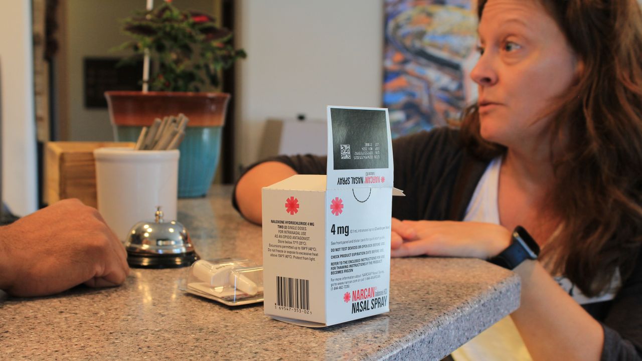Shannan Piccolo, with the Park City-County Health Department in Montana, talks with a hotel manager about how to use Narcan nasal spray to reverse a drug overdose. 