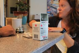 Shannan Piccolo, with the Park City-County Health Department in Montana, talks with a hotel manager about how to use Narcan nasal spray to reverse a drug overdose. 