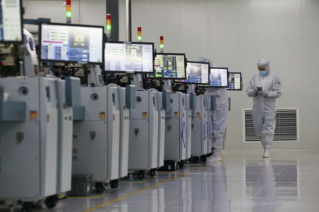 People work at a manufacturer of semiconductors in Suining in southwest China's Sichuan province Tuesday, May 24, 2022.  (FeatureChina via AP Images)