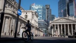 A cyclist rides past the Bank of England during the August heatwave in the City of London, the capital's financial district, on 11th August 2022, in London, England. (Photo by Richard Baker / In Pictures via Getty Images)