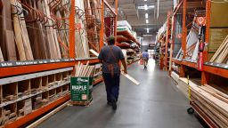 An employee works the lumber section at a Home Depot store in Alhambra, California on May 4, 2022. - The US central bank announced its biggest interest rate hike in over twenty years as it deals with fast rising home, gas and food prices in the US economy. 